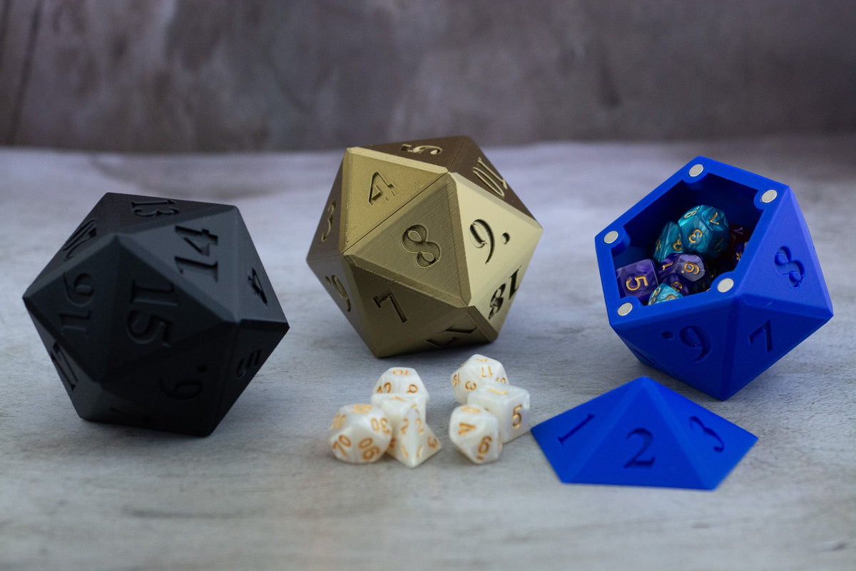 Black, gold and blue D20 dice vaults, the blue one open with dice inside
