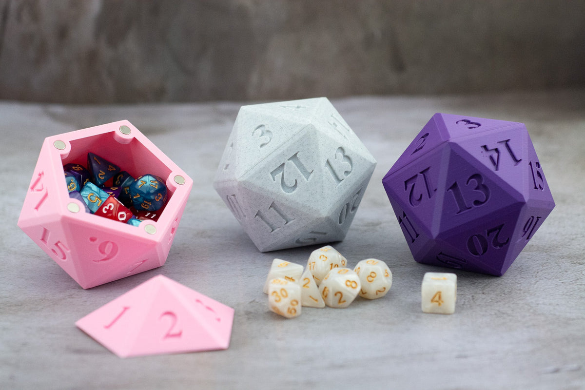 Pink, white and purple D20 dice vaults, the pink one open and full of dice