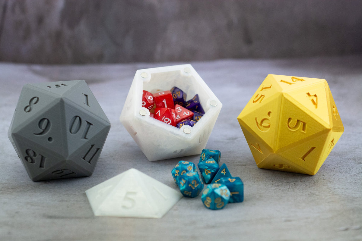 Gray, white and yellow D20 dice vaults, the white one open and full of dice