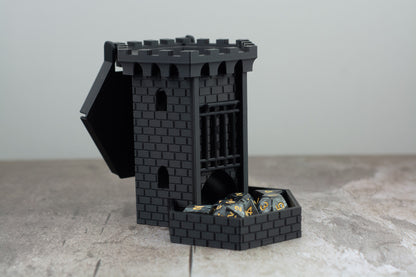 Black castle dice tower with the lid open and dice stored in the tray