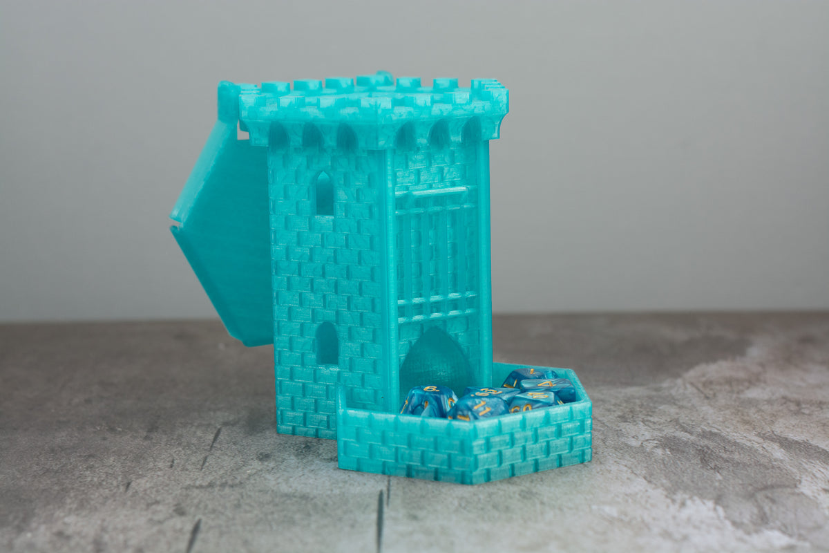 Teal castle dice tower with the lid open and dice stored in the tray