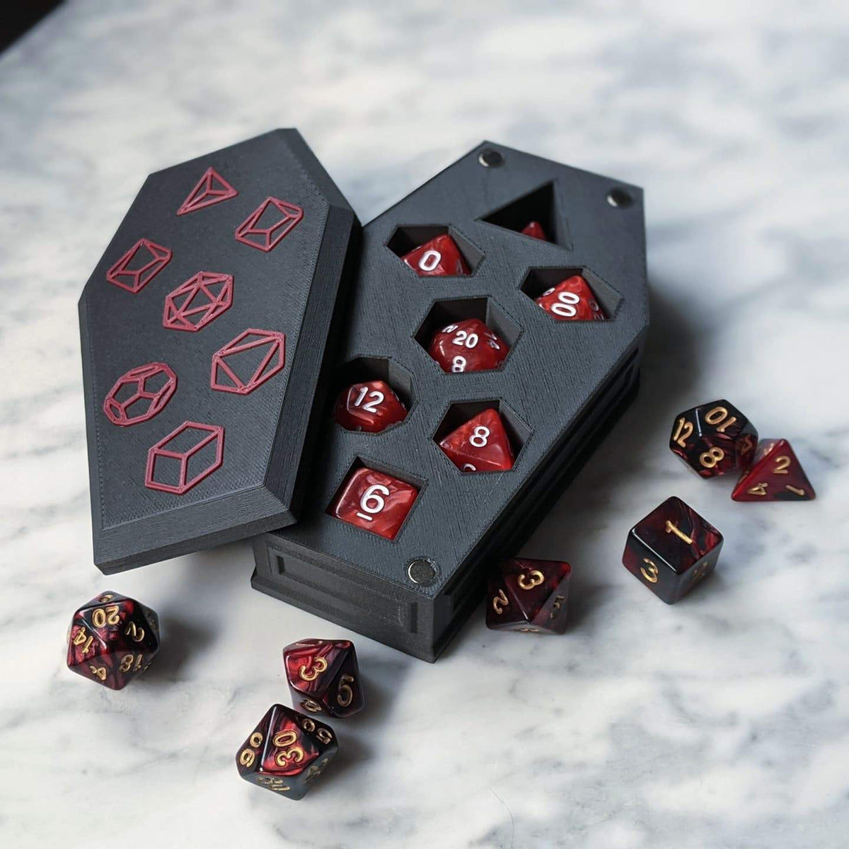 Open coffin dice vault with a red and black dice set in the slots and the lid beside it