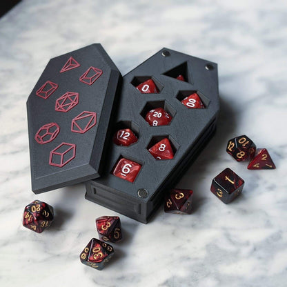 Open coffin dice vault with a red and black dice set in the slots and the lid beside it