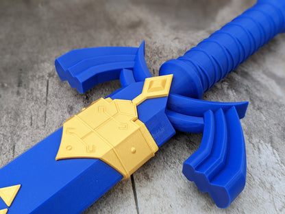 Close-up of the Master Dice Sword's winged guard and gold sheath details